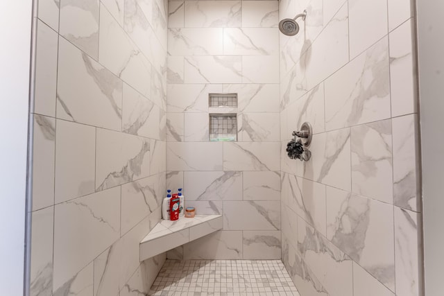 bathroom with a tile shower