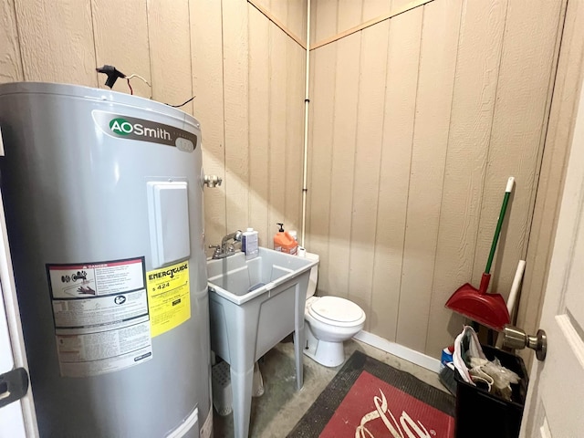 bathroom featuring water heater and concrete flooring