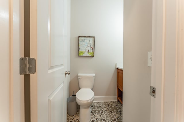 bathroom featuring tile patterned floors, vanity, and toilet