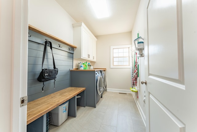 laundry area featuring washing machine and dryer and cabinets