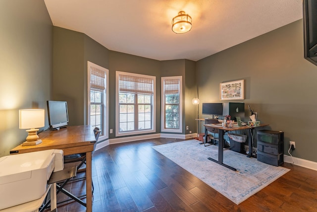 office space with dark wood-type flooring