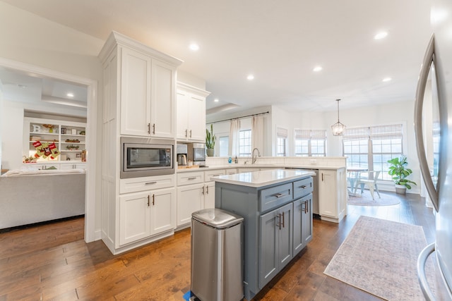 kitchen featuring appliances with stainless steel finishes, white cabinetry, gray cabinetry, sink, and dark hardwood / wood-style floors