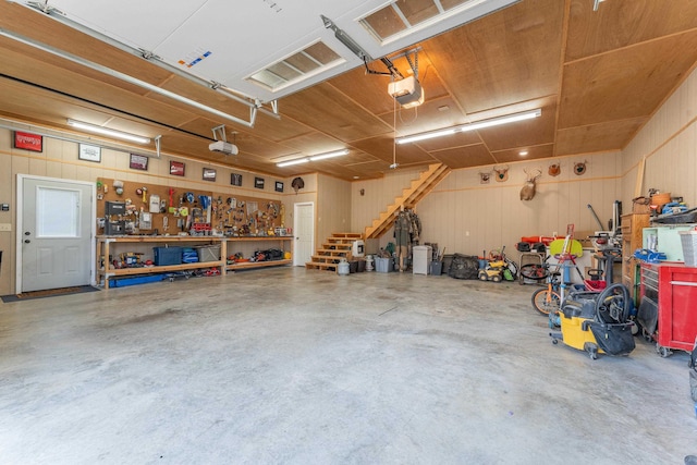 garage with a workshop area and a garage door opener