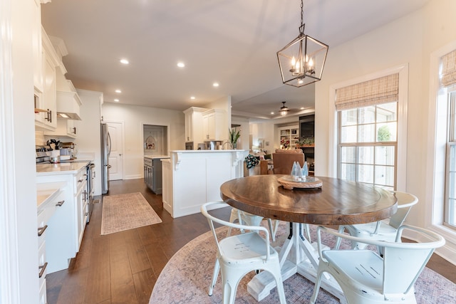 dining space featuring a notable chandelier and dark hardwood / wood-style flooring