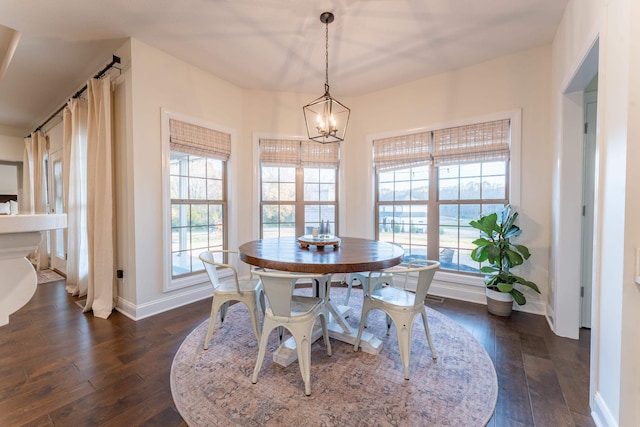 dining room with a chandelier and dark hardwood / wood-style floors