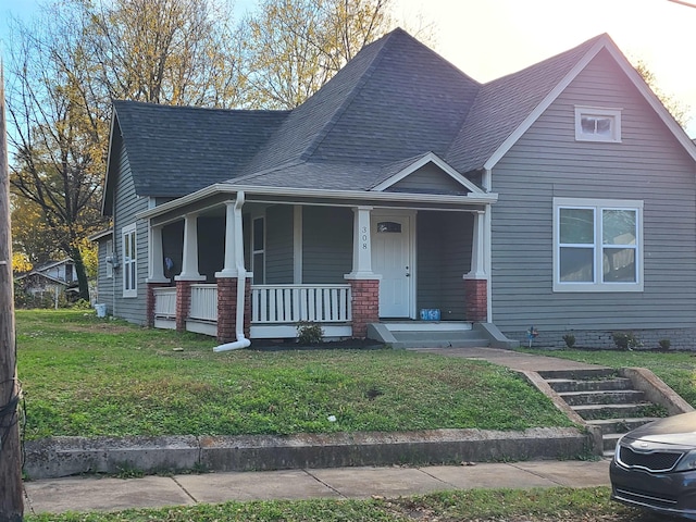 view of front of property with a porch and a front lawn