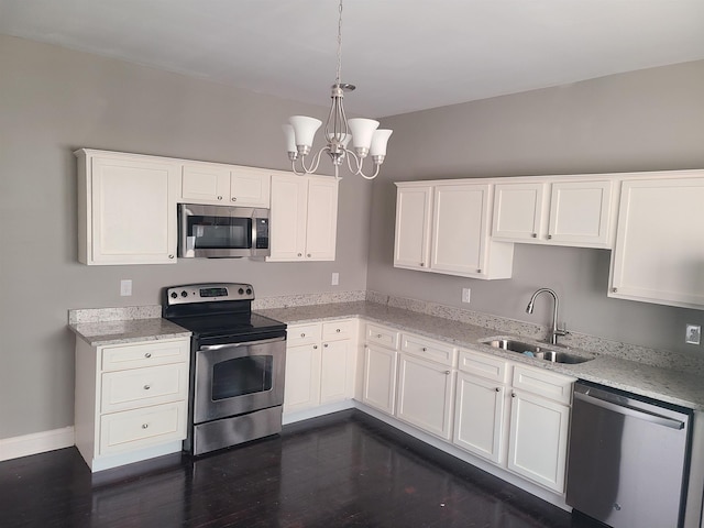 kitchen featuring white cabinets, sink, appliances with stainless steel finishes, and dark wood-type flooring