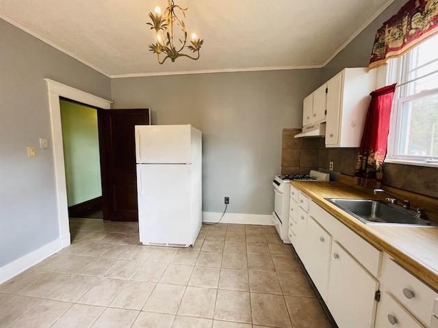 kitchen with white cabinetry, sink, an inviting chandelier, pendant lighting, and white appliances