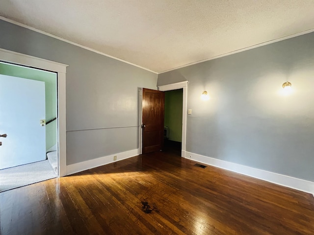 spare room featuring dark hardwood / wood-style floors and ornamental molding