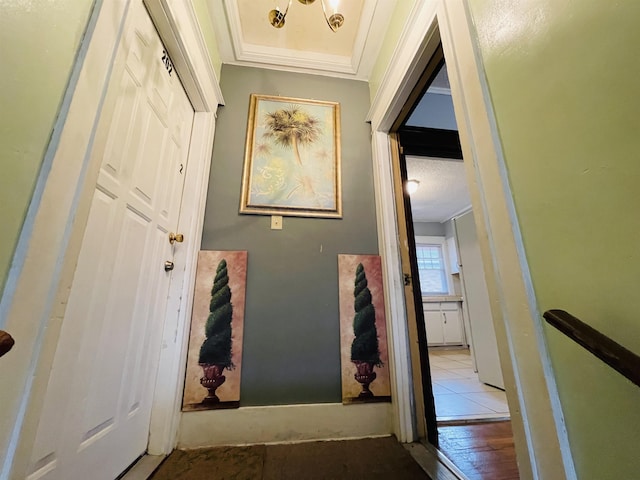 hallway featuring light wood-type flooring and ornamental molding