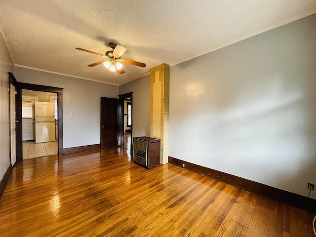 empty room featuring crown molding, hardwood / wood-style floors, ceiling fan, and a textured ceiling