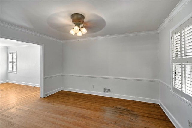 unfurnished room featuring ceiling fan, wood-type flooring, and ornamental molding