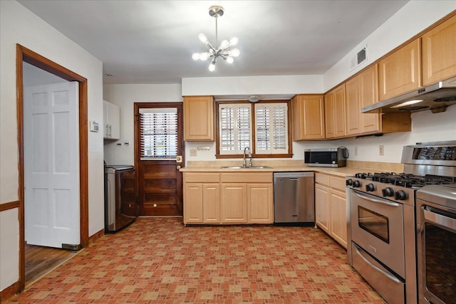 kitchen featuring sink, light brown cabinets, an inviting chandelier, pendant lighting, and appliances with stainless steel finishes