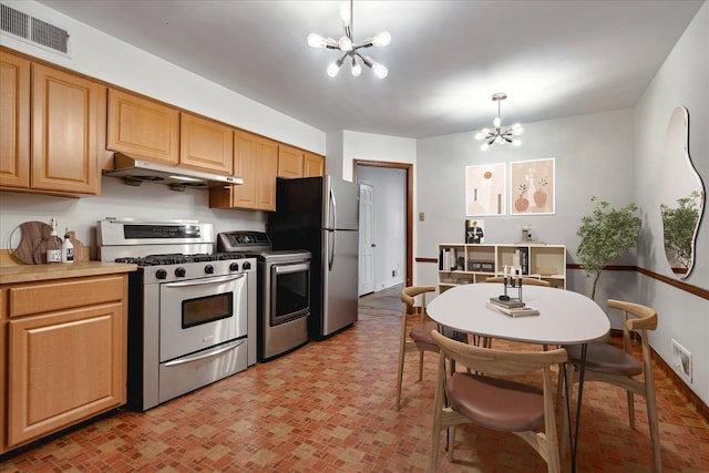 kitchen with pendant lighting, washer / clothes dryer, appliances with stainless steel finishes, and a chandelier