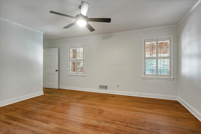 empty room with light hardwood / wood-style floors, plenty of natural light, crown molding, and ceiling fan