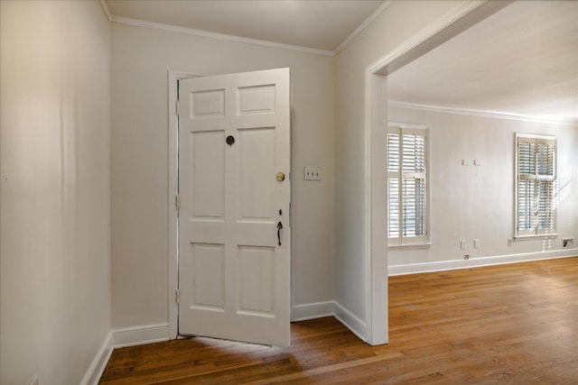 foyer entrance featuring light hardwood / wood-style floors and crown molding