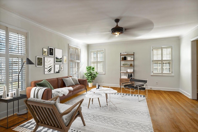 living room with plenty of natural light, light hardwood / wood-style floors, and crown molding