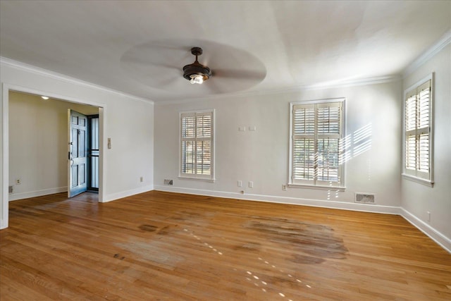 spare room with ceiling fan, plenty of natural light, ornamental molding, and light wood-type flooring