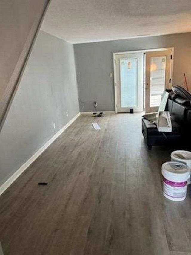 unfurnished living room featuring wood-type flooring