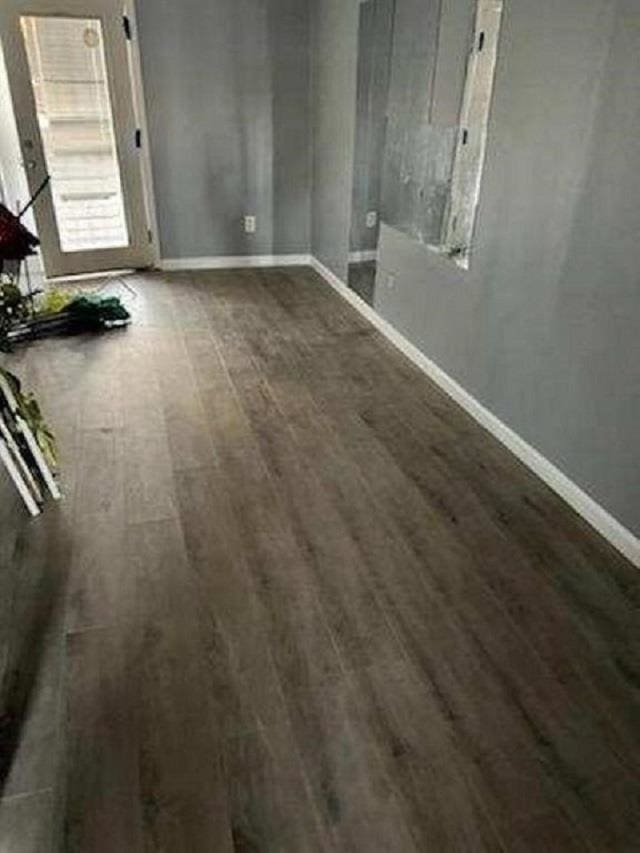 unfurnished room with dark hardwood / wood-style floors