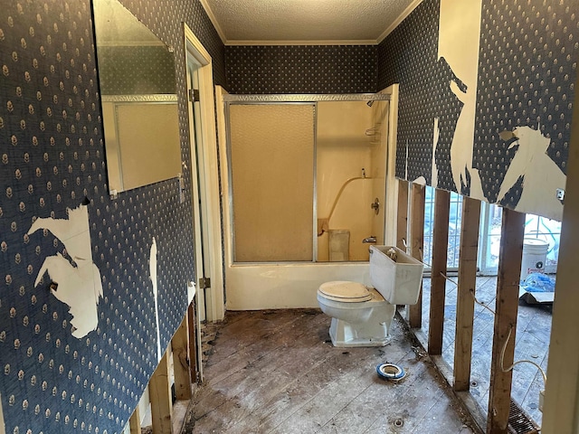 bathroom with crown molding, hardwood / wood-style floors, bath / shower combo with glass door, and a textured ceiling