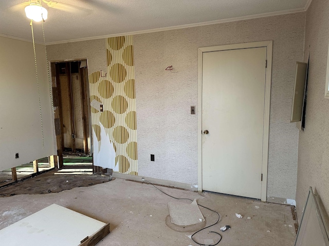 unfurnished room featuring a textured ceiling and crown molding