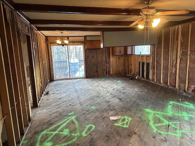 interior space featuring wood-type flooring and ceiling fan with notable chandelier