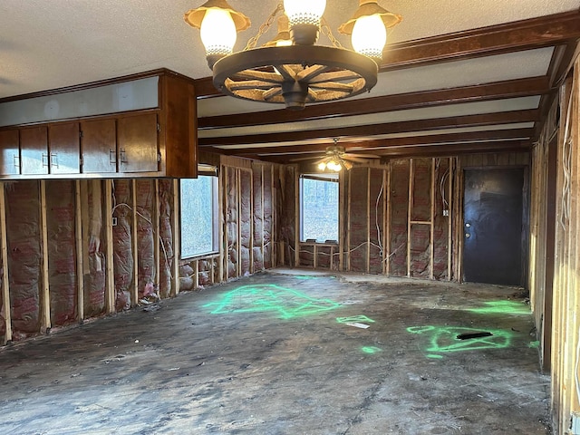 interior space featuring ceiling fan with notable chandelier and a textured ceiling