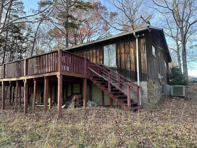 back of property featuring cooling unit and a wooden deck