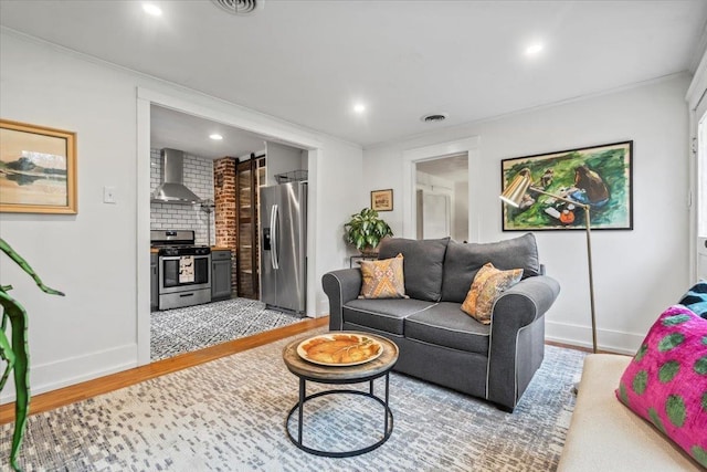 living room with hardwood / wood-style floors and ornamental molding