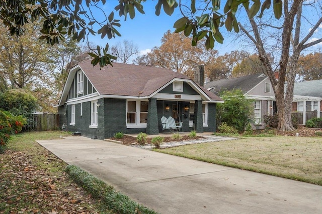 view of front of house with a porch and a front lawn