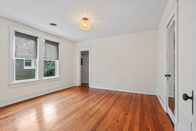 empty room with hardwood / wood-style floors