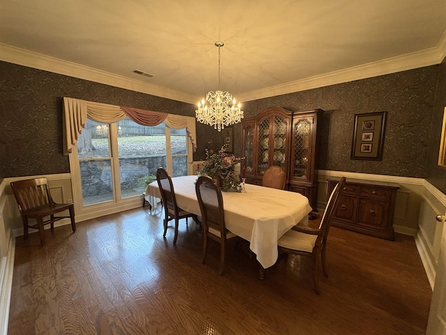 dining area with a chandelier, hardwood / wood-style flooring, and crown molding