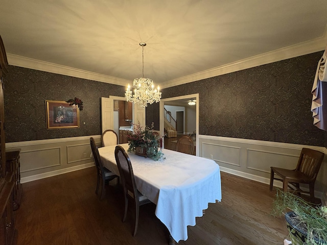 dining room with dark hardwood / wood-style floors, ornamental molding, and a chandelier