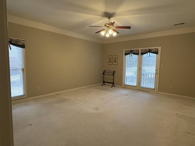 empty room featuring carpet, ceiling fan, and ornamental molding