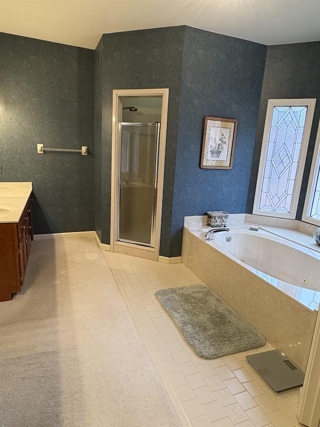 bathroom with tile patterned floors, vanity, and separate shower and tub