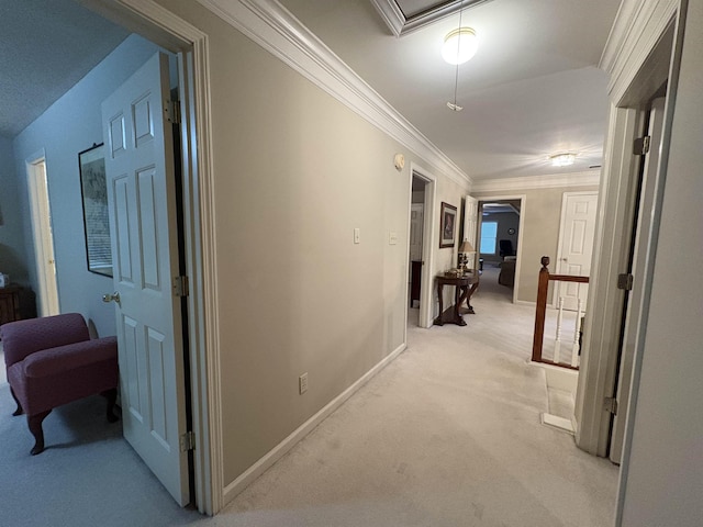 corridor with ornamental molding and light carpet