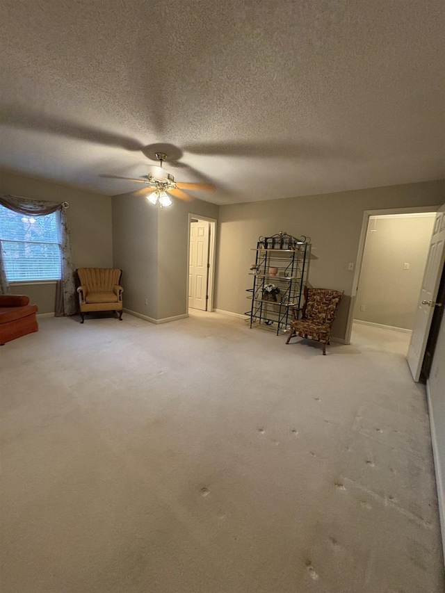 unfurnished room with ceiling fan, carpet, and a textured ceiling