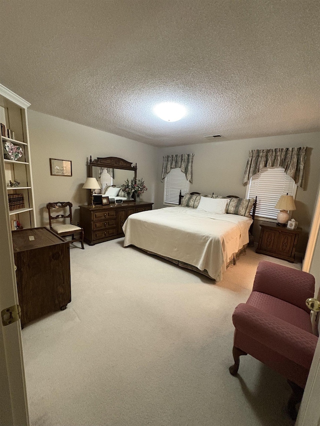 carpeted bedroom with a textured ceiling