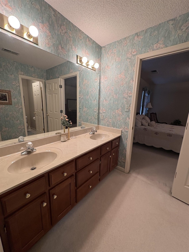 bathroom featuring vanity, a textured ceiling, and toilet