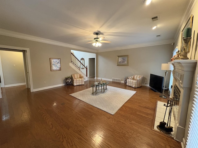 living room with ceiling fan, dark wood-type flooring, and ornamental molding