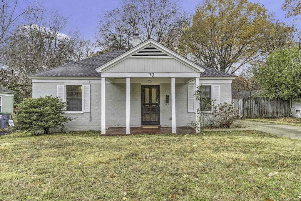 bungalow with a porch and a front yard