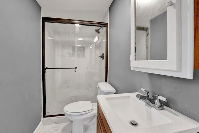 bathroom with vanity, toilet, and a shower with door