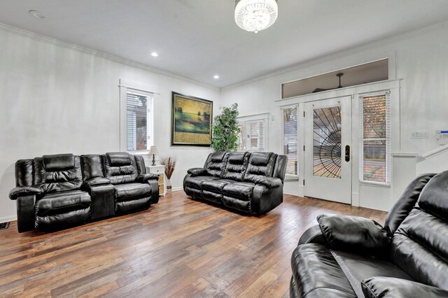 living room featuring hardwood / wood-style flooring and crown molding