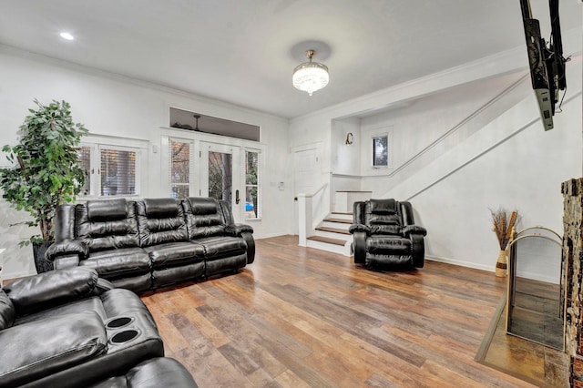 living room with hardwood / wood-style floors, french doors, and ornamental molding