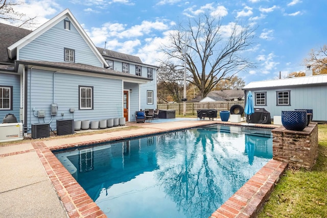 view of swimming pool featuring cooling unit, a jacuzzi, and a patio