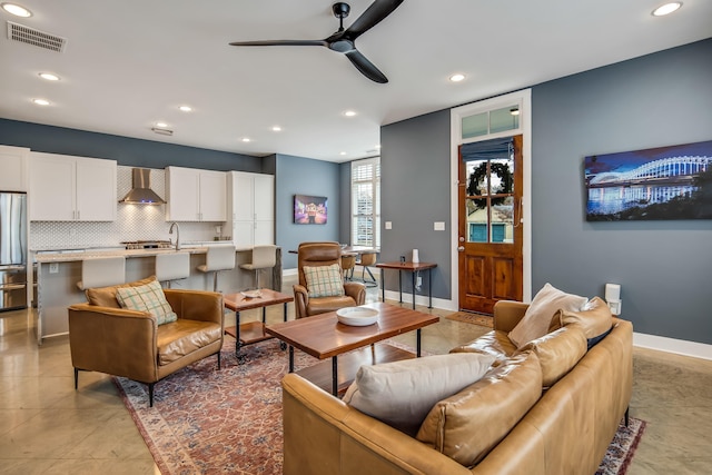 living room featuring sink and ceiling fan