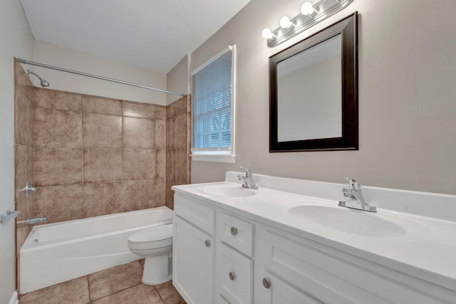 full bathroom with toilet, tile patterned flooring, vanity, and tiled shower / bath