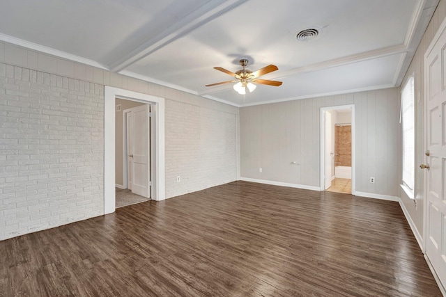 spare room featuring dark hardwood / wood-style floors, plenty of natural light, and brick wall