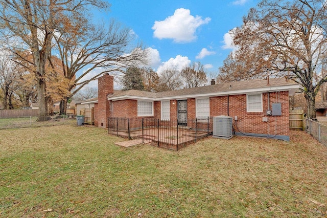 rear view of house featuring a patio area, a yard, and cooling unit